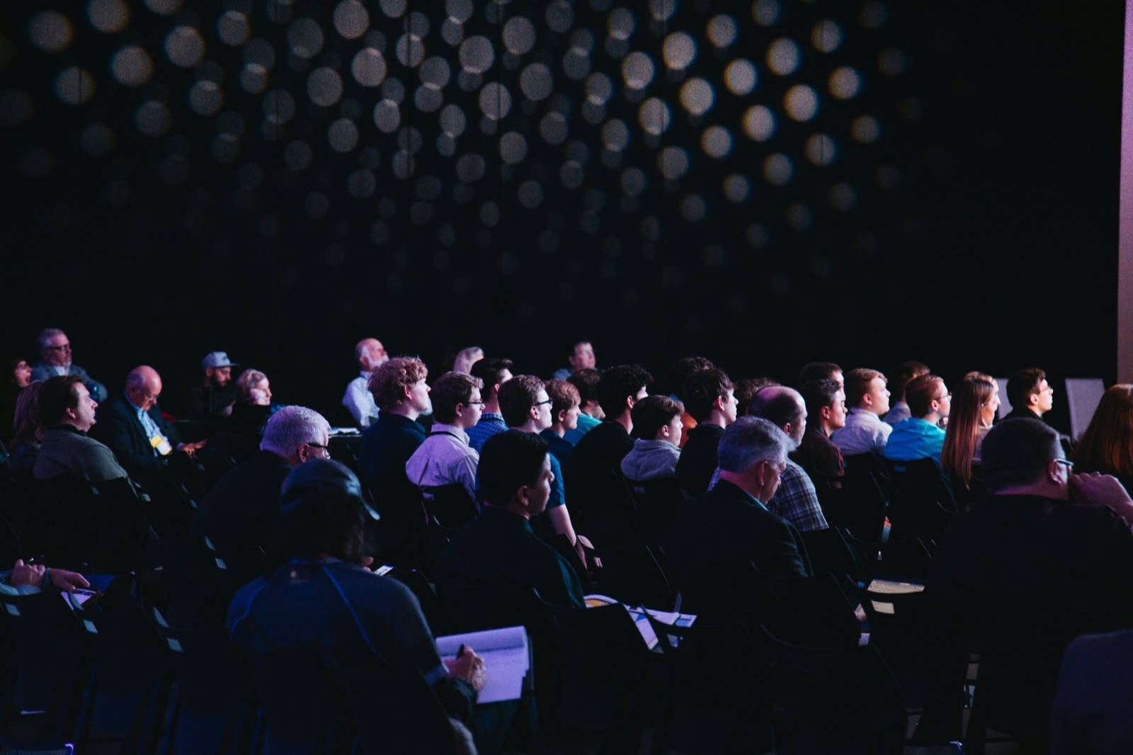 A full audience seated in a dimly lit hall during the awards ceremony