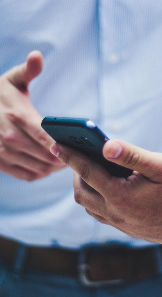 Close-up of a person holding a phone while talking