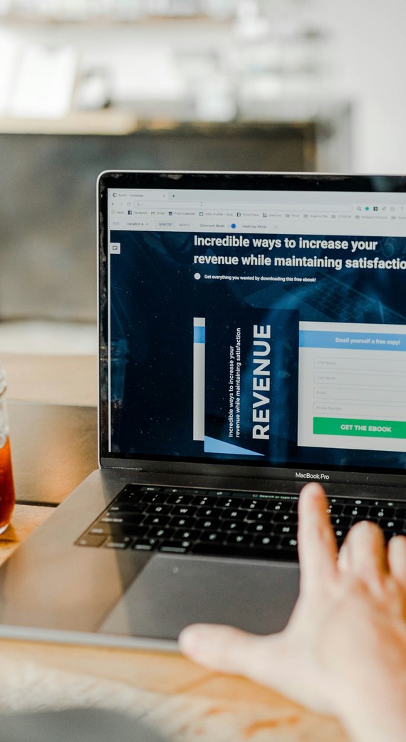 A laptop showing a landing page with a download form