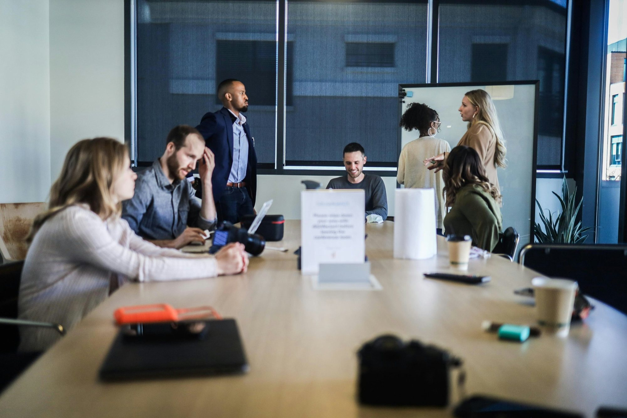 Team meeting around a table planning social media content in a conference room