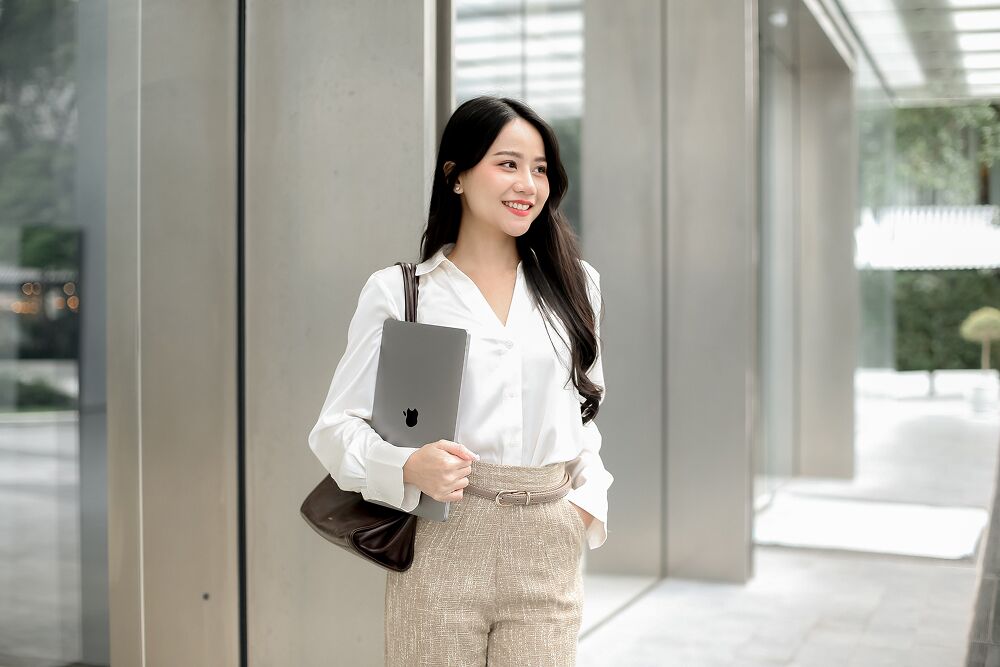 A Primal team member walking through the office lobby with a laptop